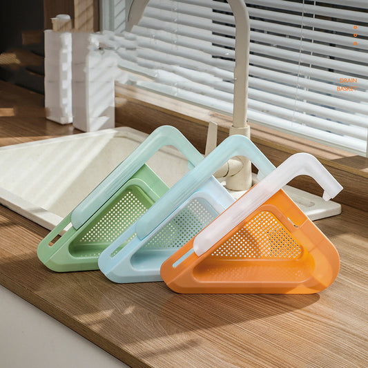Three triangular kitchen tools in green, blue, and orange on a wooden surface.